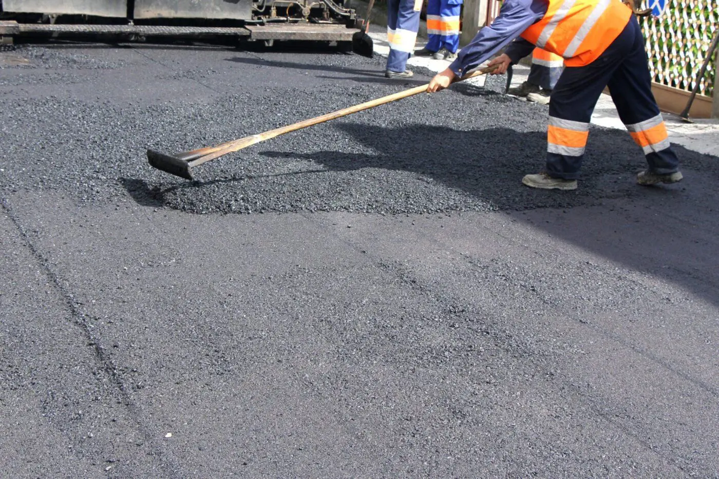 asphalt worker cutting asphalt road for a hot patch
