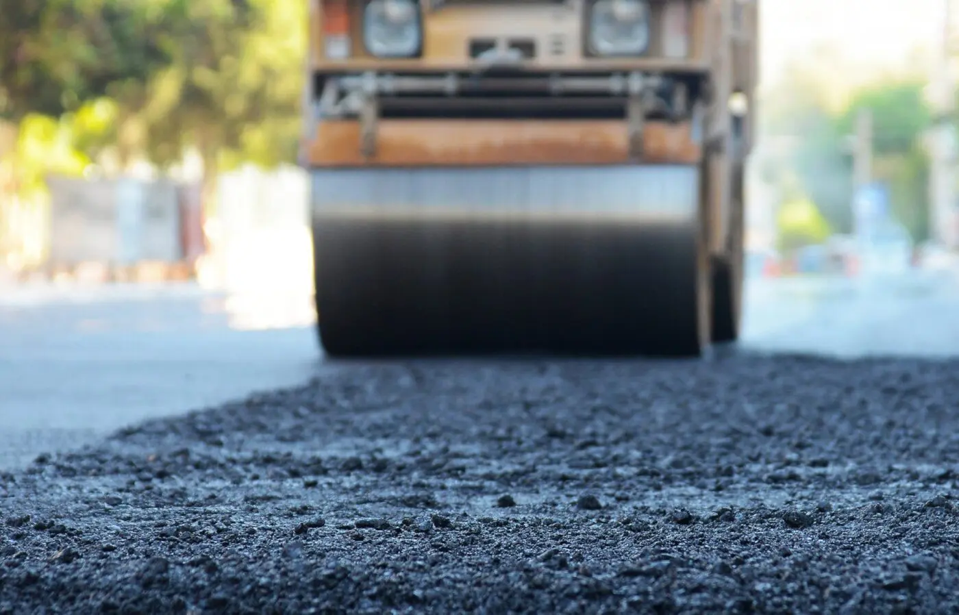 asphalt worker cutting asphalt road for a hot patch